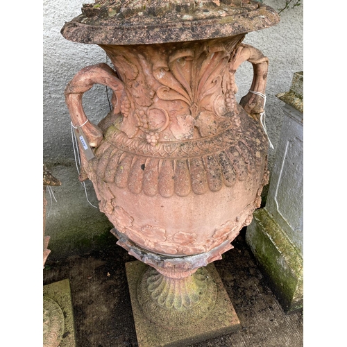 1373 - An impressive pair of terracotta coloured composition stone Garden Urns, each relief moulded with sc... 