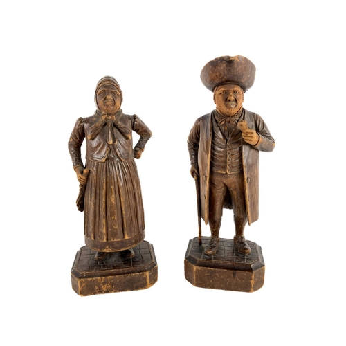 1005 - A pair of 19th Century Dutch carved wooden Figures, of a man and woman wearing typical attire, each ... 