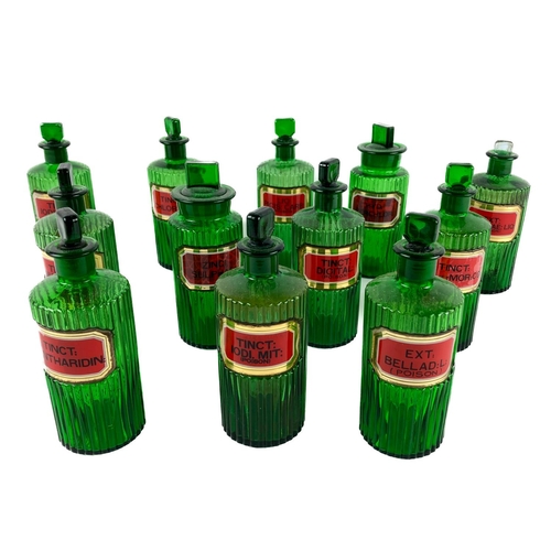 371 - A collection of 12 rare reeded and green coloured Apothecary Bottles, with lids, with painted labels... 