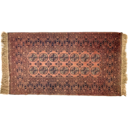 727 - A large rust ground Bokhara Rug, with two rows of octagons inside a multi border, 194cms x 110cms (7... 