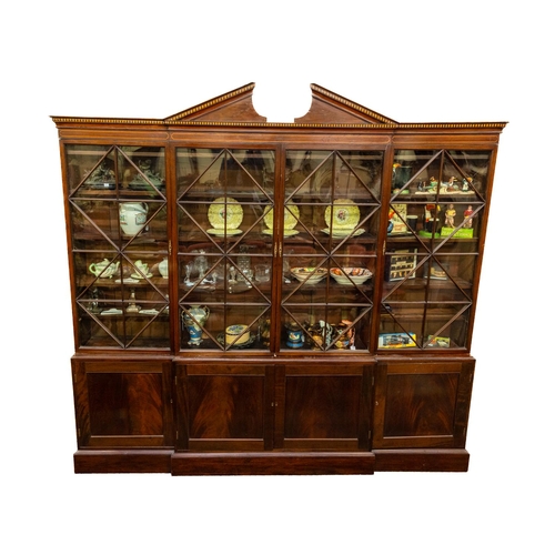 794 - A fine George III inlaid mahogany breakfront Library Bookcase, the divided pediment above an arrange... 