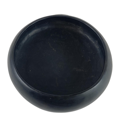 877 - A rare South American black Pottery four legged Bowl, of circular ogee form, in the Pre-Columbian st... 