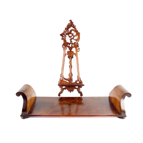 921 - A Victorian mahogany Bookstand, with scroll ends on four bun feet, 57cms (22