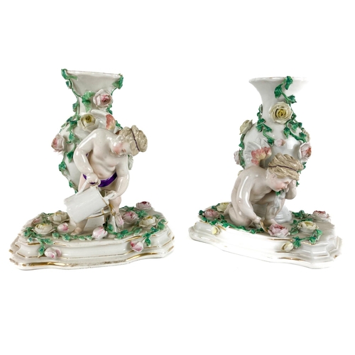 978 - A pair of Sitzendorf flower encrusted baluster shaped Vases, with Gardener and Cherubs on rectangula... 