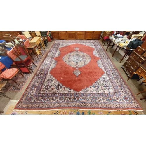 1113 - A very large burgundy ground Oriental wool Carpet, with large centre fawn floral medallion with conf... 