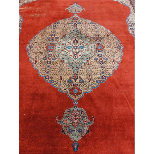 1113 - A very large burgundy ground Oriental wool Carpet, with large centre fawn floral medallion with conf... 