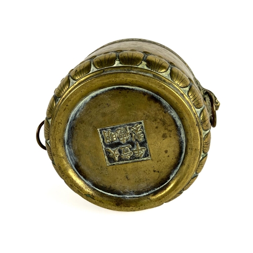 287 - A heavy Chinese brass Brush Pot, with two grotesque temple lion masks with ring suspenders, the edge... 