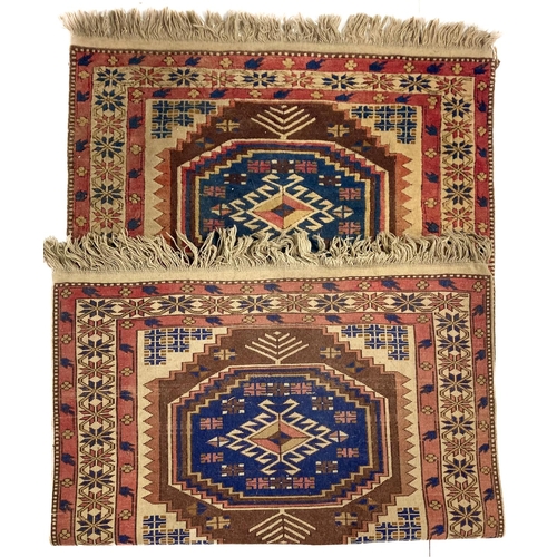 729 - A semi-antique Caucasian Kazak Rug, with three large octagonal medallions, the rust, black and ... 