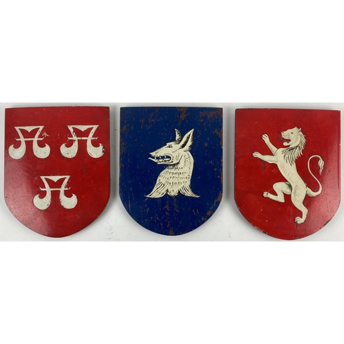 763 - A set of 3 shield shaped painted mahogany Panels, all with different crest, 24cms (9 1/2'). (3)... 