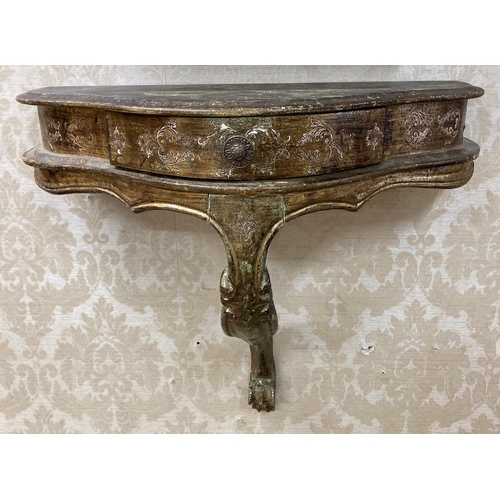 513 - A Continental style Pier Table, with green and gilt design, embossed flowers, shaped top over frieze... 