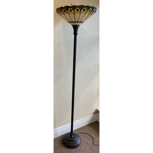 596 - A tall bronzed Tiffany style Floor or Standard Lamp, with upward lighting stained glass shade on a t... 