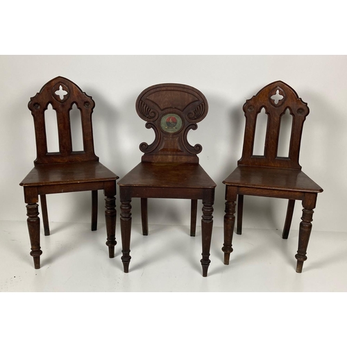 670 - A William IV period mahogany Hall Chair, with shield shaped back with central painted crest above a ... 