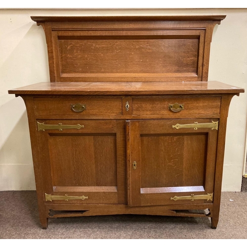 790 - An Arts & Crafts oak Sideboard, with panelled back above two frieze drawers with brass handles o... 