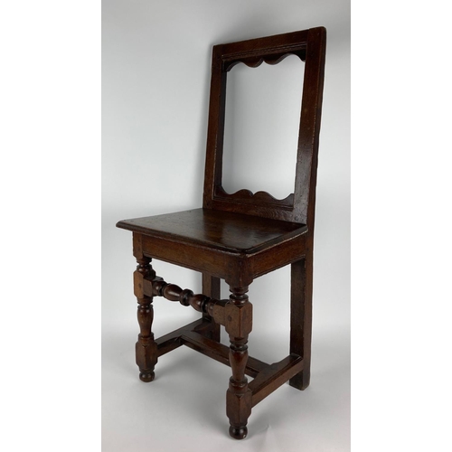 828 - A 17th Century style Child's oak Low Chair, with open back and solid seat. (1)