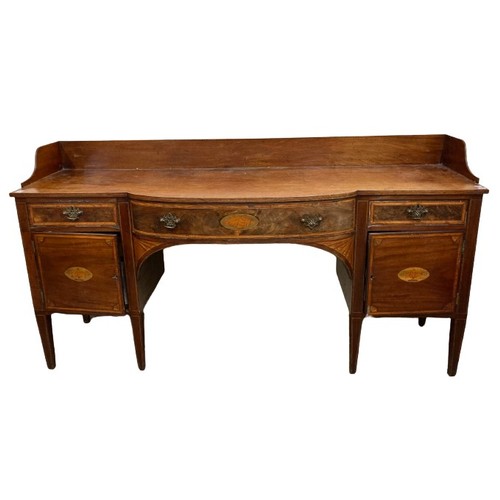 984 - A George IV period inlaid mahogany Sideboard, with three-quarter gallery, the bow fronted centre wit... 