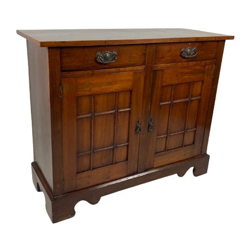 989 - An Edwardian walnut Cupboard, with two frieze drawers above two multi panel doors on a plinth base, ... 