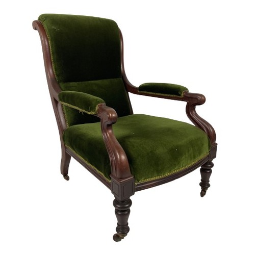 1034 - A Victorian mahogany Armchair, with padded back, seat and elbow rests covered in green fabric on fro... 