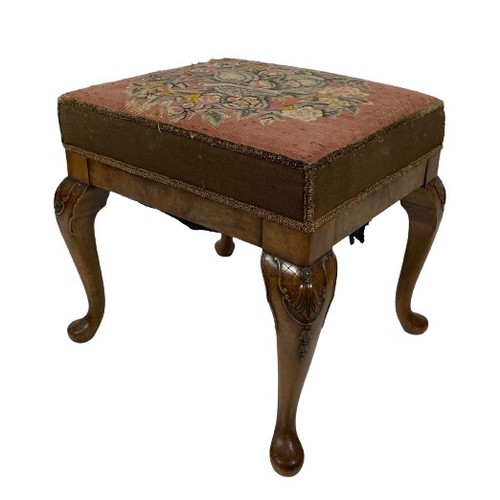 1059 - A Georgian style walnut Footstool, with carved cabriole legs and pad feet, the seat upholstered in e... 