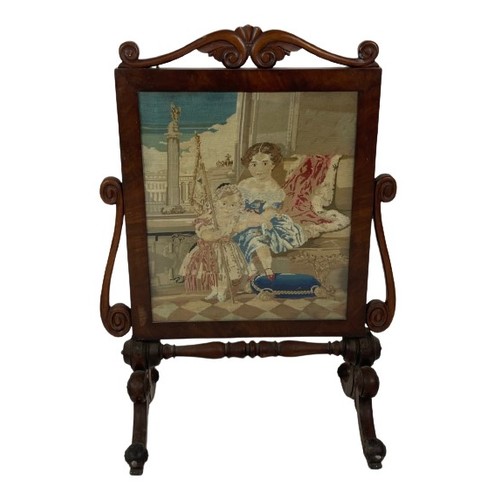 1063 - A Victorian mahogany cheval Firescreen, with tapestry panel depicting two children in an interior cr... 