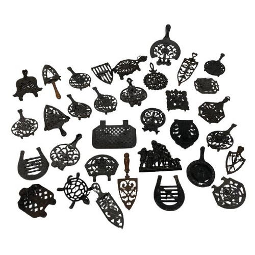 1067 - A large collection of approx. 30 cast iron Trifids and iron Stands, of variant design and sizes, som... 