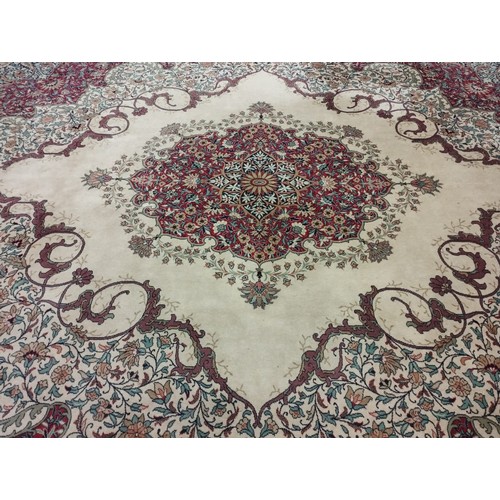 1112 - A fine quality Axminister cream ground Middle Eastern style machine turned woollen Carpet, the large... 