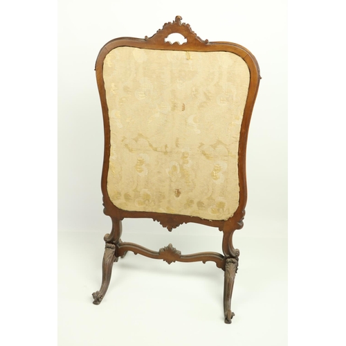 19 - A cartouche shaped Victorian mahogany cheval Firescreen, with stump work and needle work panel on qu... 