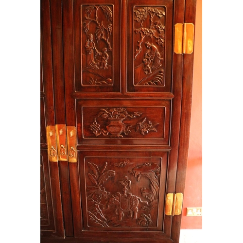 41 - A carved hardwood Cabinet (GUI) Qing Dynasty, of rectangular outline with a pair of hinged doors sep... 