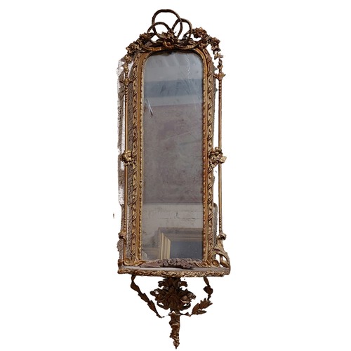 69 - A 19th Century gilt Pier Mirror, the arched top crested with a ribbon bow and flower head, on a ribb... 