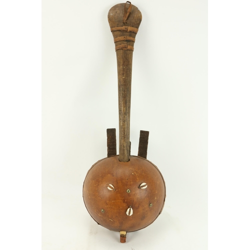 75 - A 19th Century West African Kora, with hide covering and shell decoration. (1)