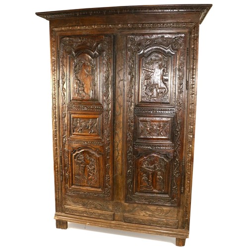 8 - A heavy carved late 18th Century Continental walnut and oak Cupboard, the two triple panel doors eac... 