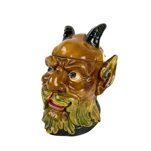 47 - A rare Continental Majolica type Biscuit Barrel, modelled as a horned bearded figure, stamped with n... 