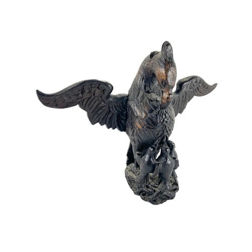 48 - A carved wooden Eagle Crest, with chicks and outstretched later wings, 33cms (13