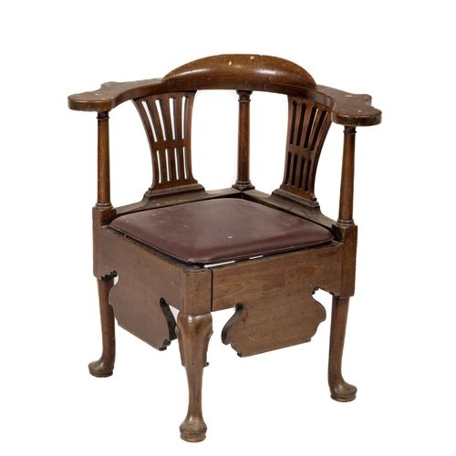 116 - A George III walnut Corner Armchair, with shaped flat arm rests and above two pierced splats and tur... 