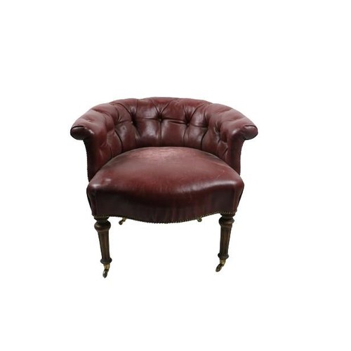 98 - An Edwardian Tub Armchair, covered in deep button red leather on front reeded legs with bass castors... 