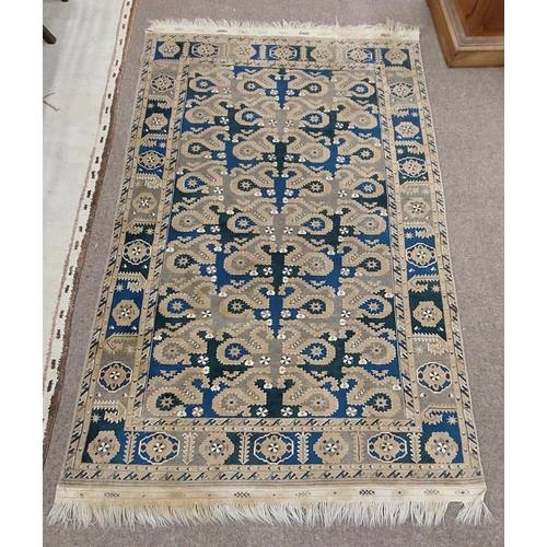 426 - A semi-antique Middle Eastern blue and green ground geometric and diamond design Carpet, the large c... 