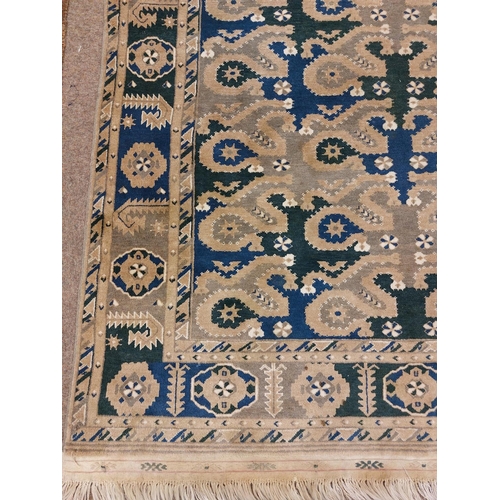 426 - A semi-antique Middle Eastern blue and green ground geometric and diamond design Carpet, the large c... 