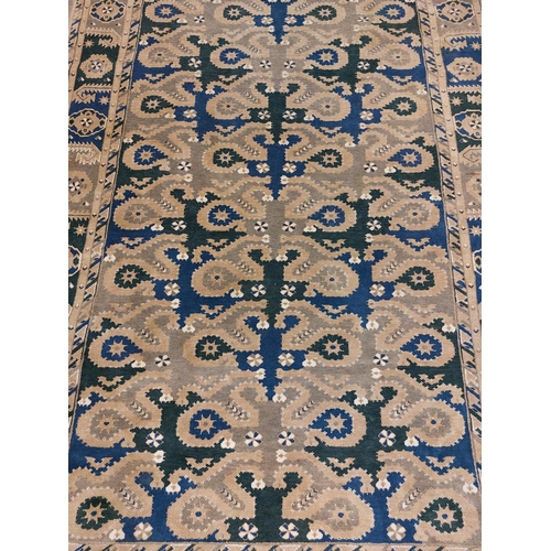 426 - A semi-antique Middle Eastern blue and green ground geometric and diamond design Carpet, the large c... 