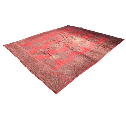 415 - A large Oriental design woollen Carpet, probably Donegal, on overall red ground with floral geometri... 