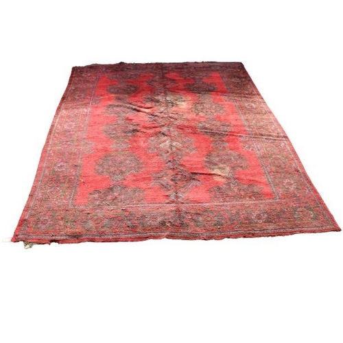 415 - A large Oriental design woollen Carpet, probably Donegal, on overall red ground with floral geometri... 