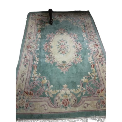 416 - An attractive heavy woollen Chinese green ground floral decorated Carpet, approx. 253cms x 172cms (8... 