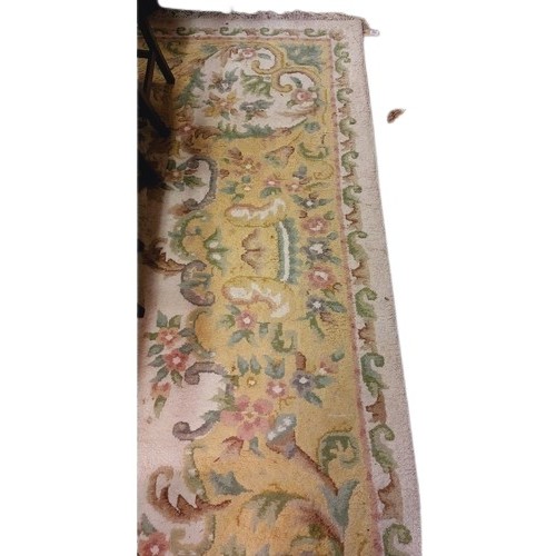 418 - A large cream ground heavy woollen Carpet, with central floral panel and shaped similar decorated bo... 