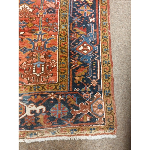 413 - A fine quality semi-antique heavy woollen Carpet, the central panel on burgundy ground with floral a... 