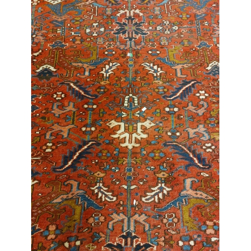 413 - A fine quality semi-antique heavy woollen Carpet, the central panel on burgundy ground with floral a... 