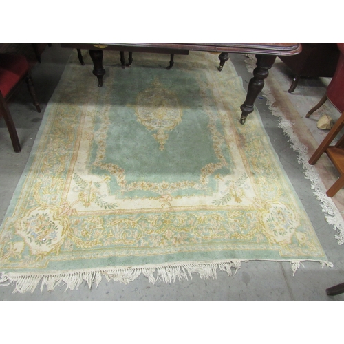 422 - A lime ground heavy woollen classic design Carpet, with central medallion trophy motif corners insid... 