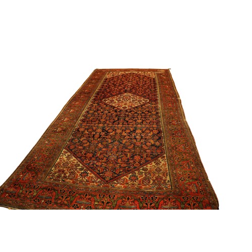 1196 - A large semi-antique woollen Carpet, the central navy ground panel with floral design, and cream gro... 