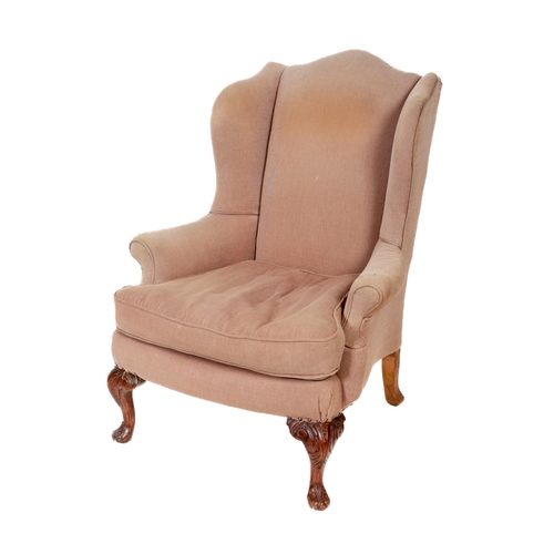 1035 - A 19th Century mahogany framed wing back Armchair, covered in cream fabric, with loose cushion, on f... 