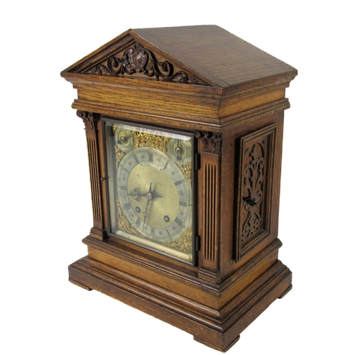 1052 - An oak cased 20th Century German made brass and steel dial Bracket Clock, the arched hood over glaze... 