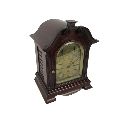 1054 - An attractive mahogany cased Mantle Clock, with swan neck pediment over an arched glazed door housin... 