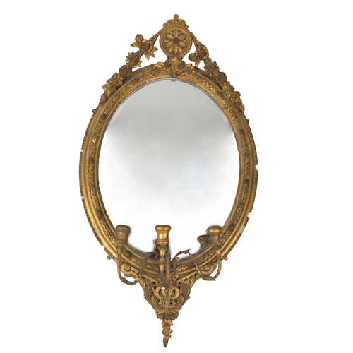 1072 - A Victorian giltwood Girandole, the oval frame with ornate cartouche and decorative border, with thr... 