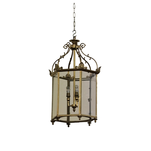 1182 - A Georgian style brass Hall Lantern, domed top with scrolled supports over an octagonal frame with g... 